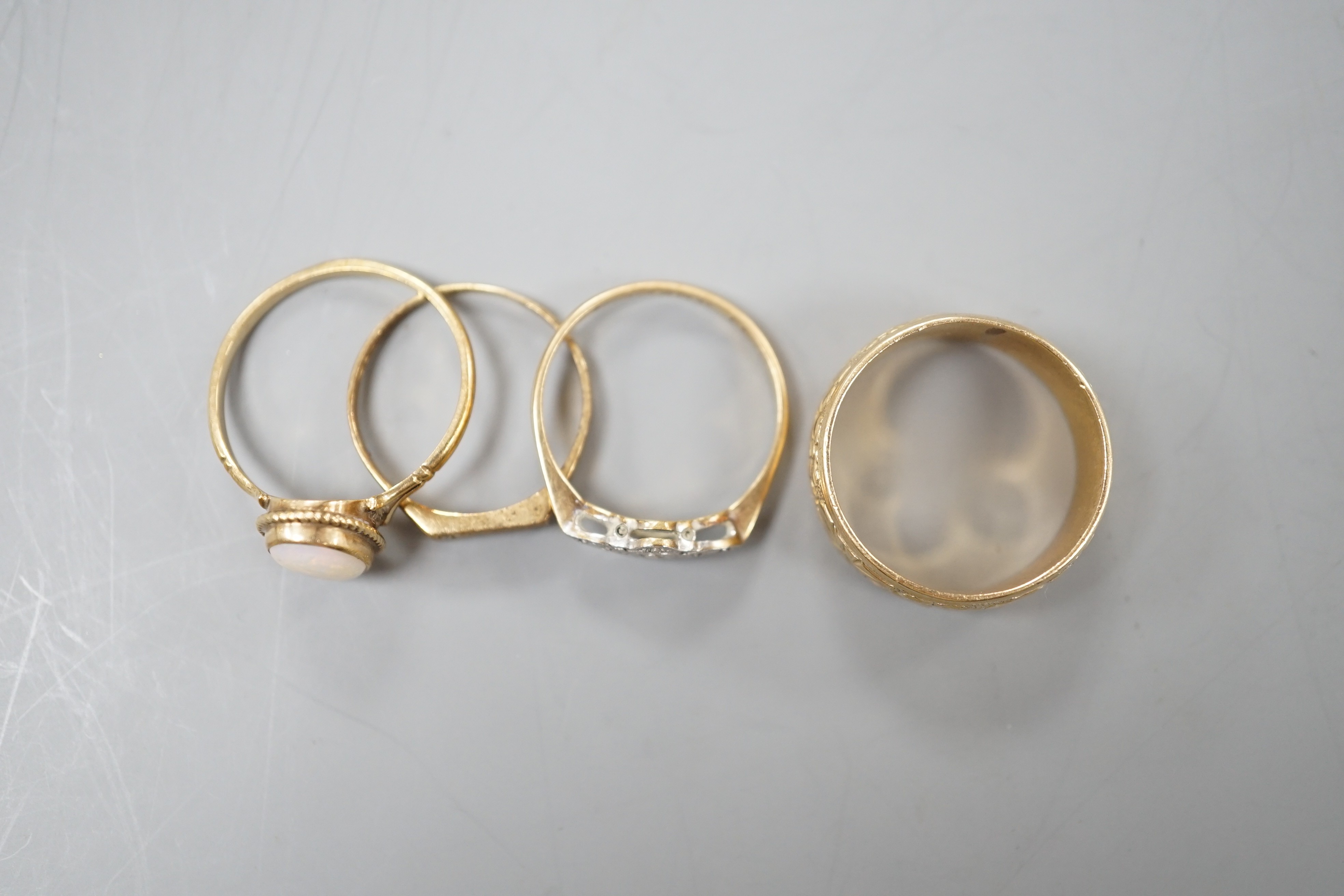Four assorted 9ct rings, including band, white opal set, diamond chip set and millegrain diamond set, gross 11 grams.